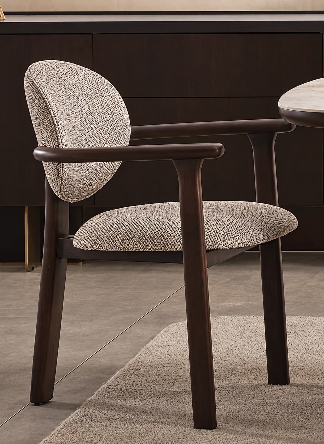 Sol armchairs around a dining table in a dark, warm interior